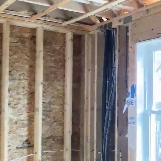 Cable run down a stud bay through new framing before the walls close up