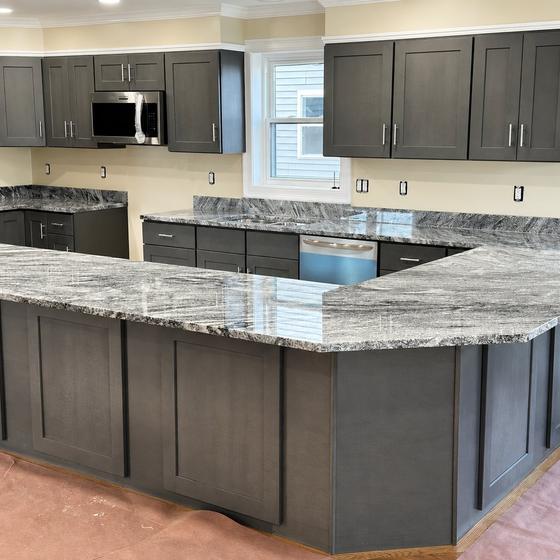 Grey Shaker cabinets with a granite peninsula and island