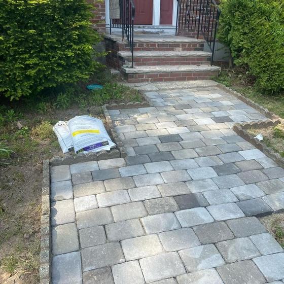 Finished paver walkway leading to a front entry