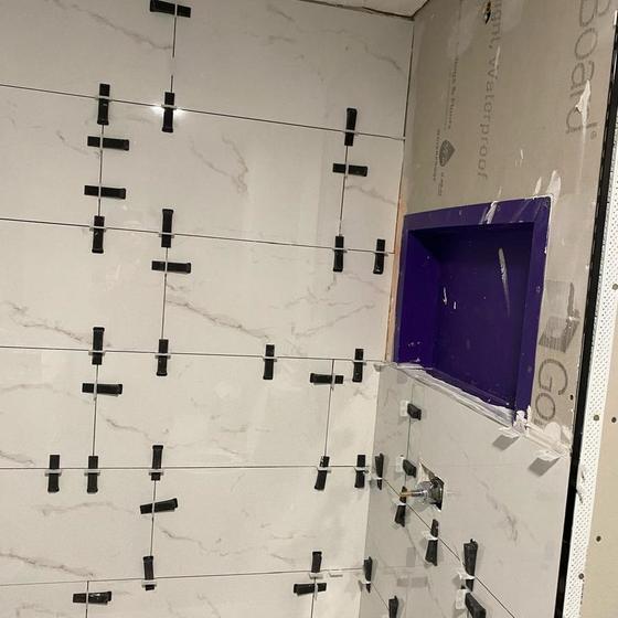 Large format shower wall tile set with levelling clips