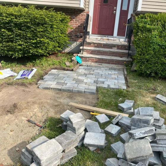 Pavers being laid on a compacted base